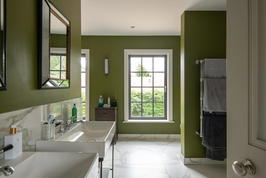 Bathroom with sash window and green walls at a multiple backdrop shoot location.