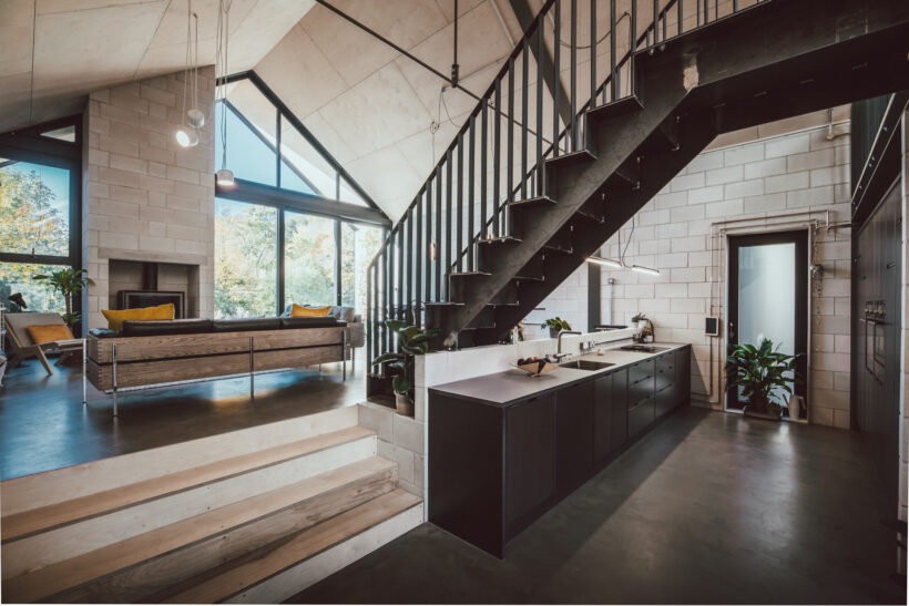 Open plan living room with poured concrete floor, concrete walls and a concrete ceiling, architectural shoot location south yorkshire.