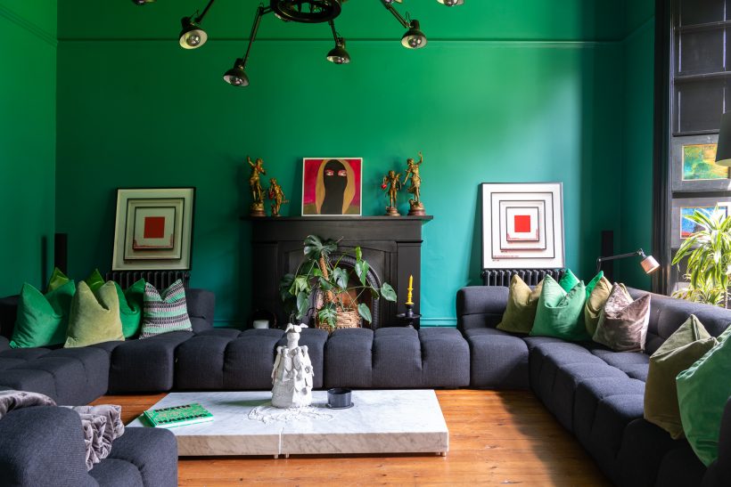 Living room with deep green walls, as per the 2025 interior design trend known as colour drenching