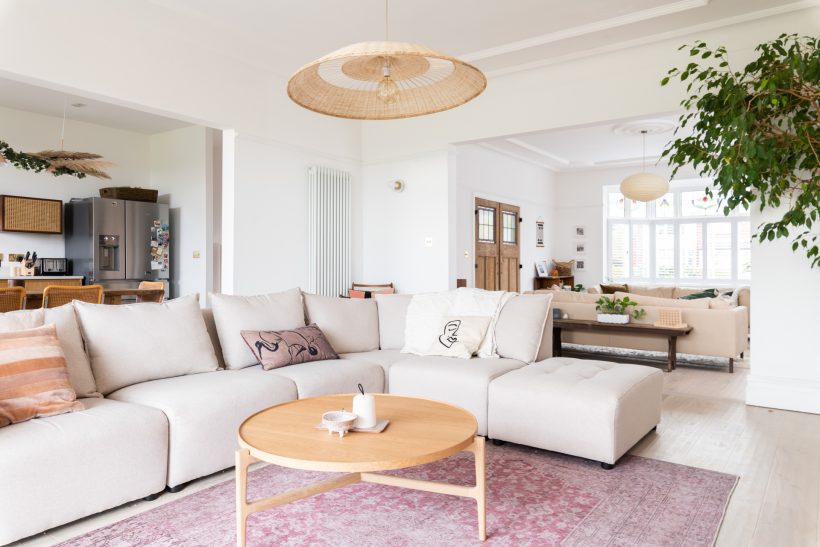 Scandi-style open plan kitchen and living room with large cream L-shaped sofa