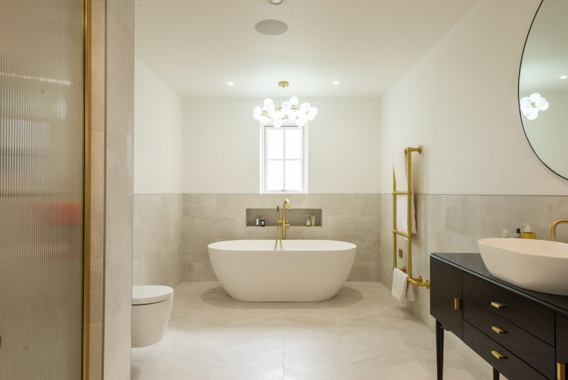 Beige and cream-coloured luxury 'spathroom' featuring freestanding bath.