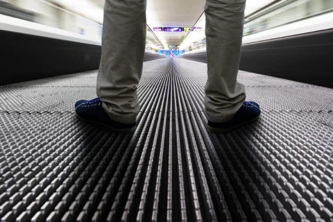 Man stood on travelator facing forwards