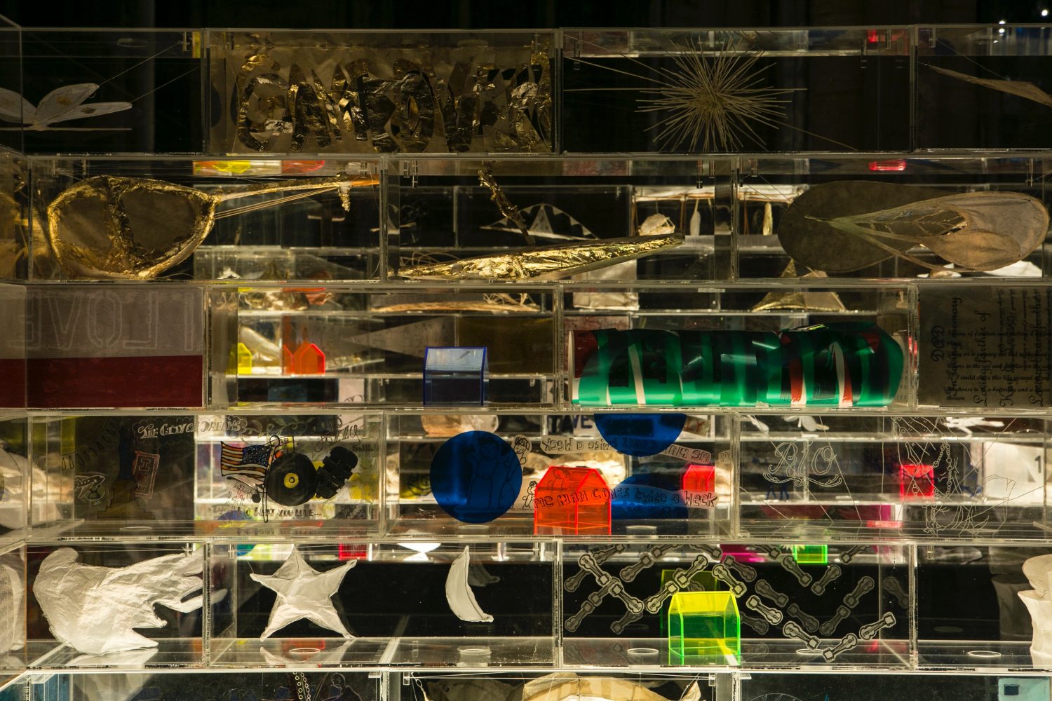 Perspex boxes with different coloured items in each box