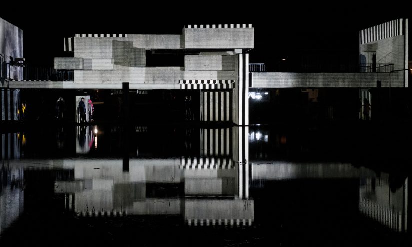 Apollo pavilion lit up with a black and white striped projection