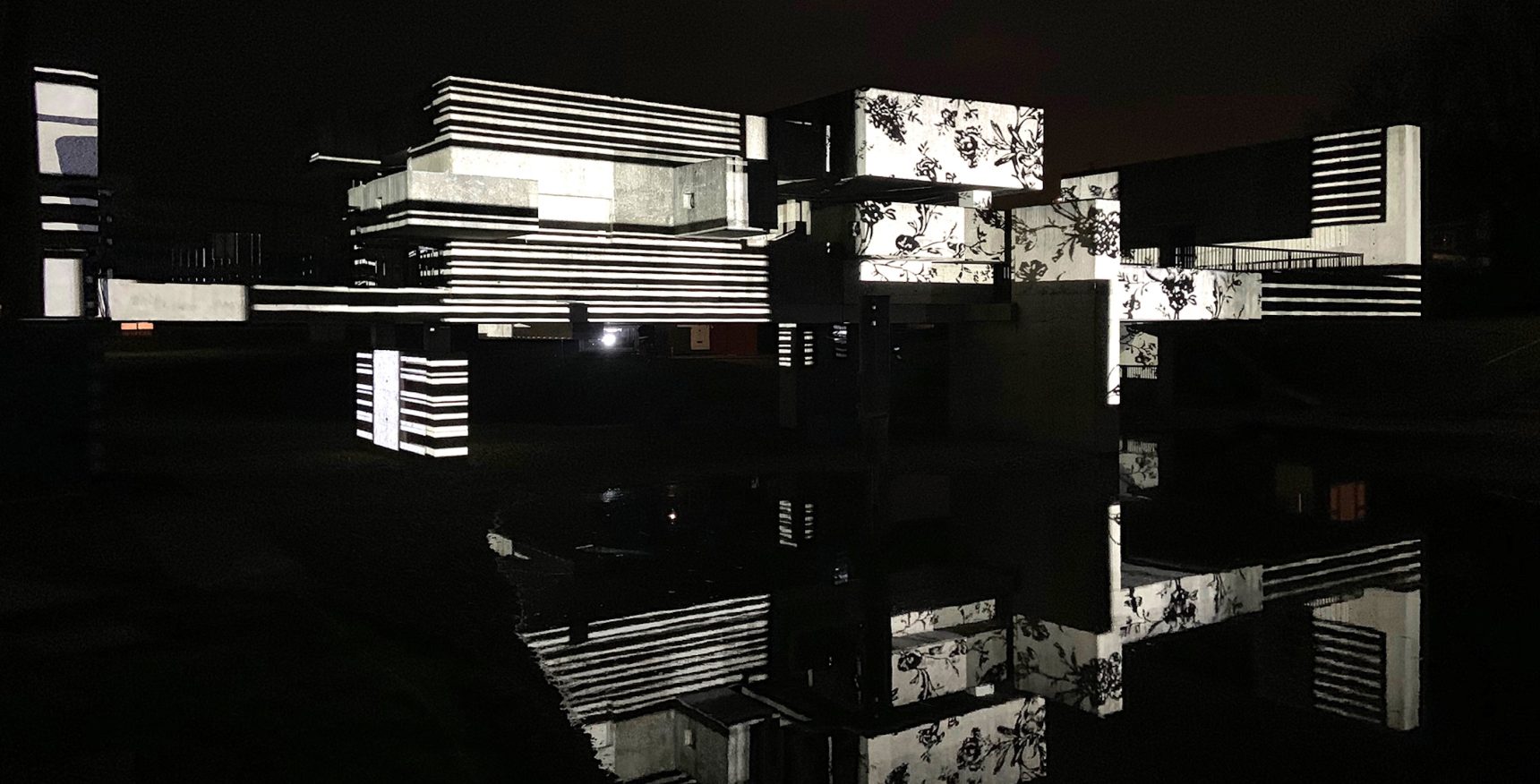 Apollo pavilion lit up with a black and white striped projection