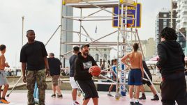 Basketball players on the court in front of scaffolding