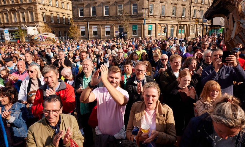 The audience at the finale HERD event, in St George's Square, cheer.