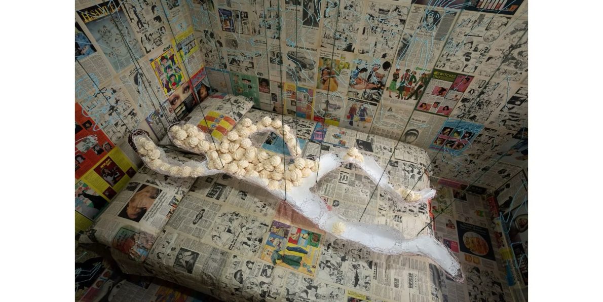 Daughter figure made of meringues and walls plastered with 1970s magazines and newspapers for An Edible Family in a Mobile Home at Tate Britain as part of Women in Revolt! in 2023.