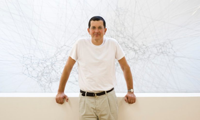Landscape image of Antony Gormley against white backdrop