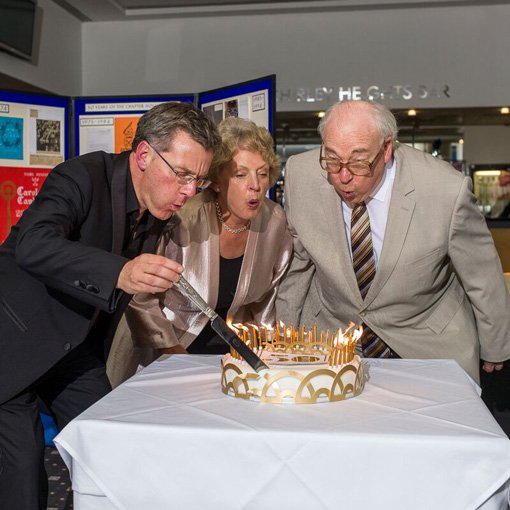 Blowing out the candles on the 50th Anniversary Cake
