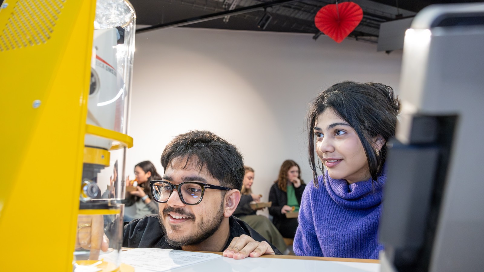 A young couple interacting with a science exhibit at a Valentines event at Techniquest in Cardiff