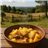 Stewed potatoes with artichokes in a homemade pot-trasera