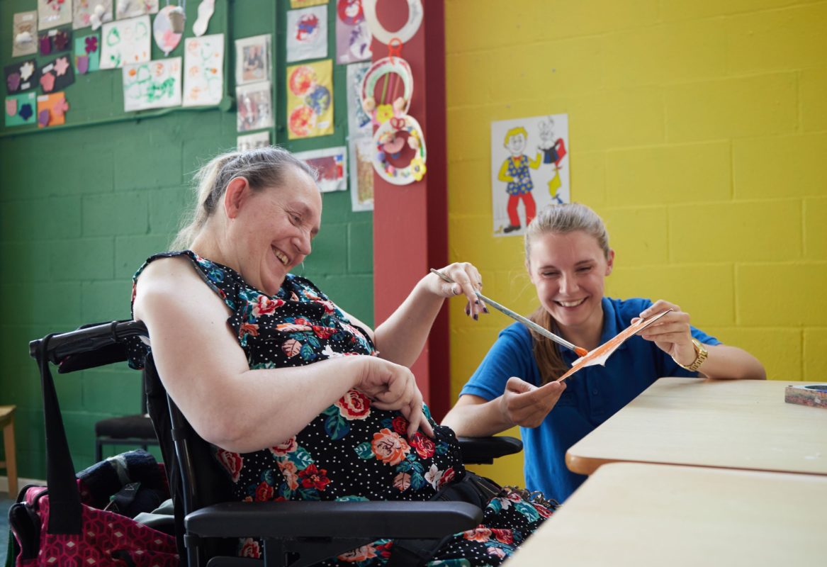 A Drummonds Care Home carer and resident painting together