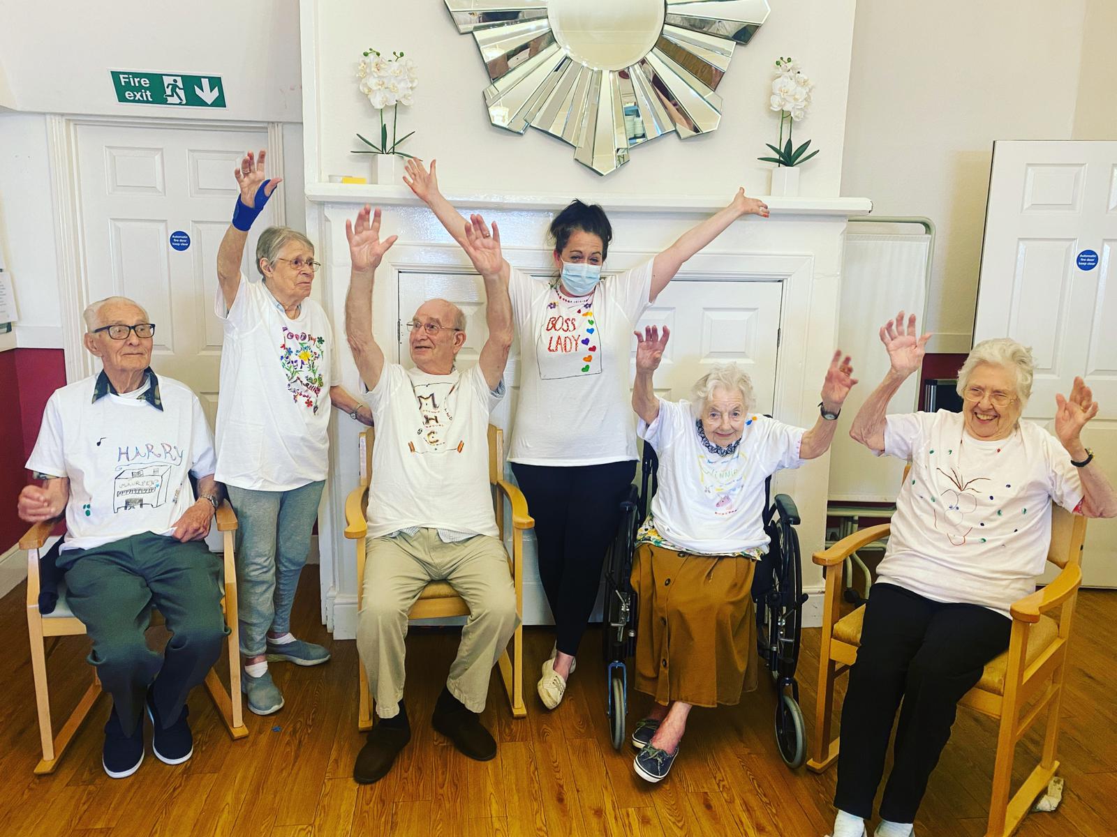 Park House residents celebrate creating their own custom T-shirts.