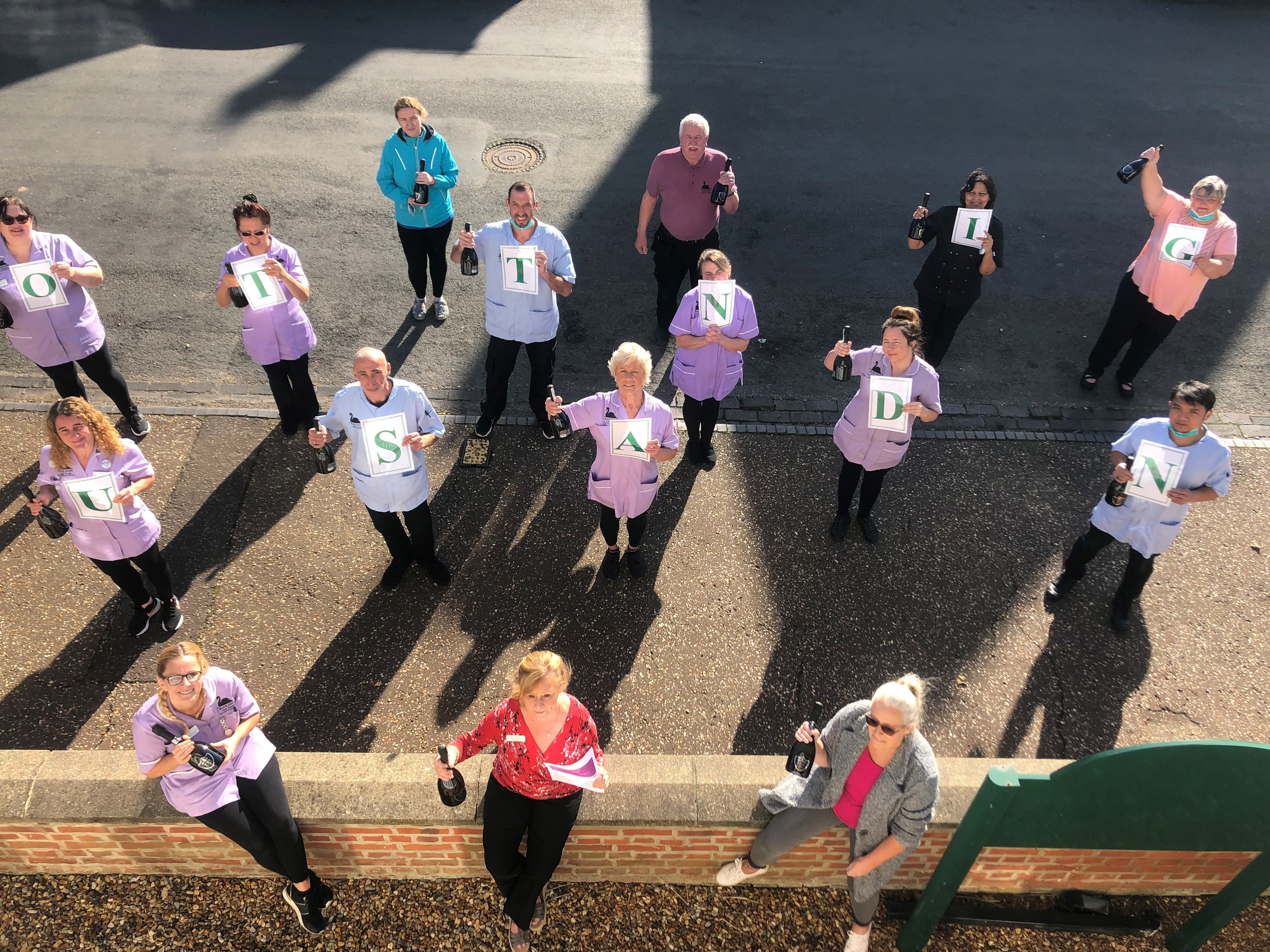 The team at Nightingale Lodge showing their pride at being rated OUTSTANDING overall by the CQC for the second time.  