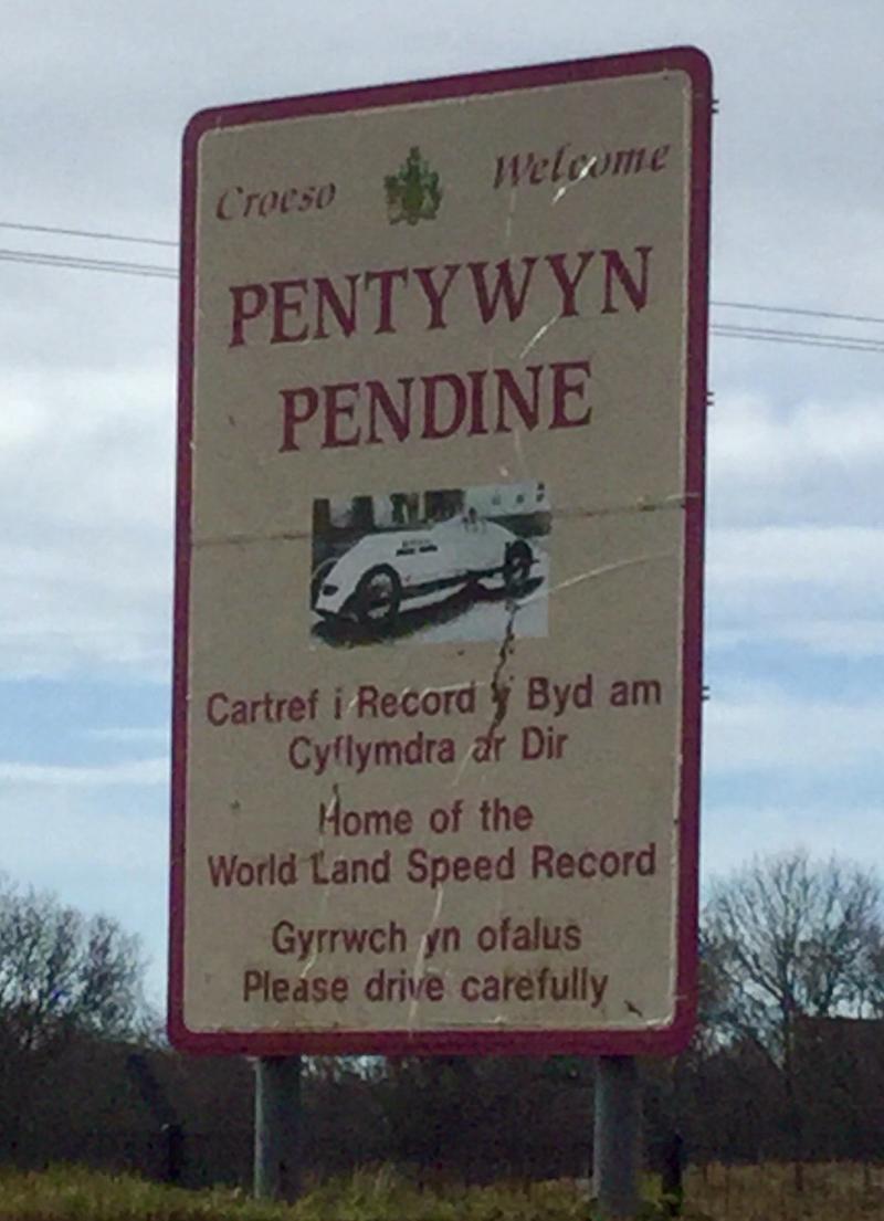The sign on the approach to the village of Pendine reveals its sporting heritage. Photo by Graham Read