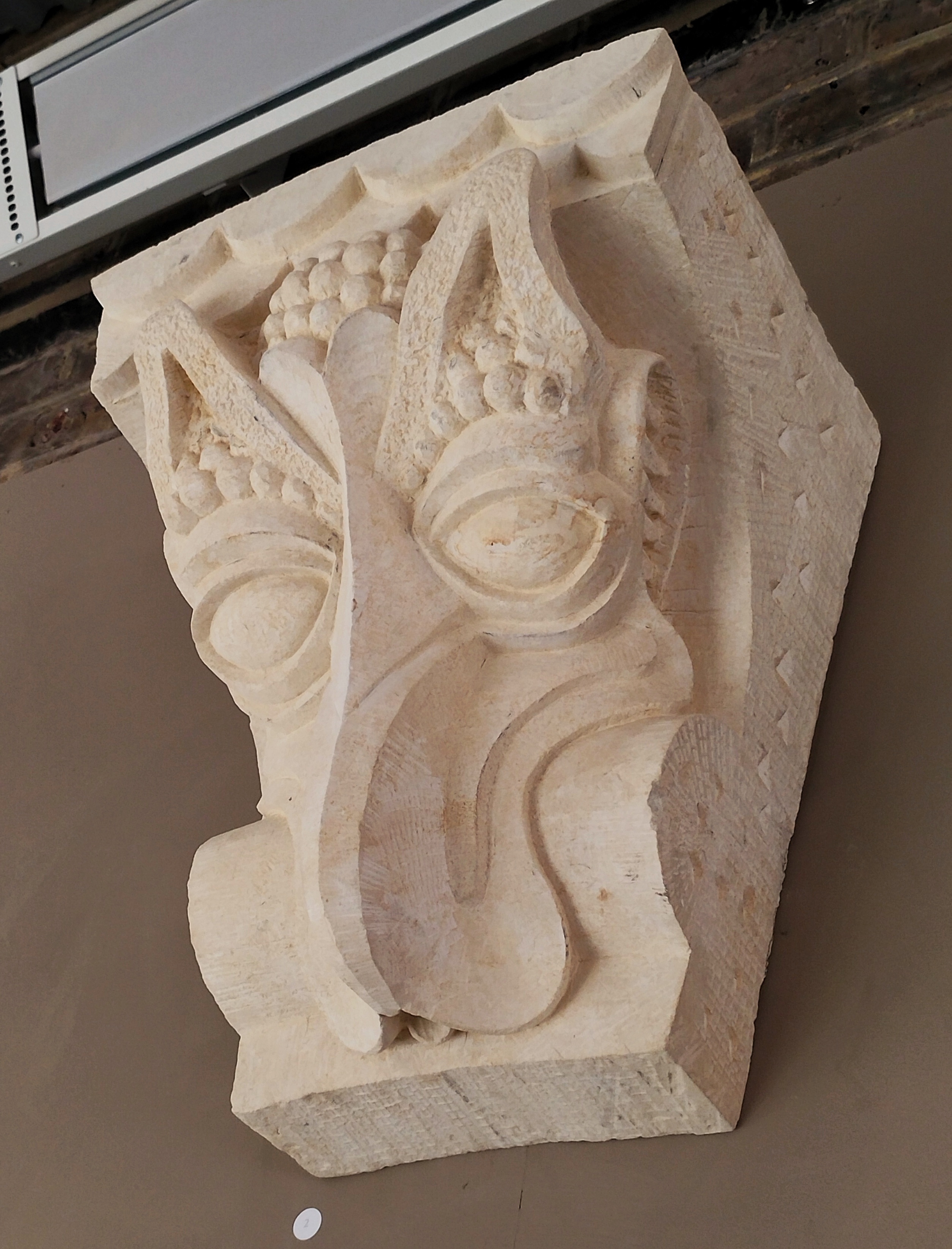 Custom design and carved Romanesque style beakhead based on a curly coated retriever