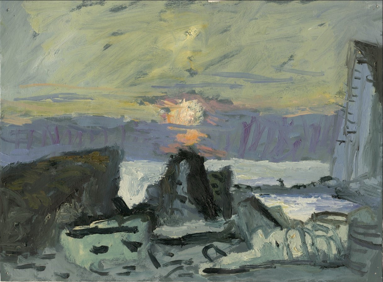 Sun sinking into cloud bank over sea