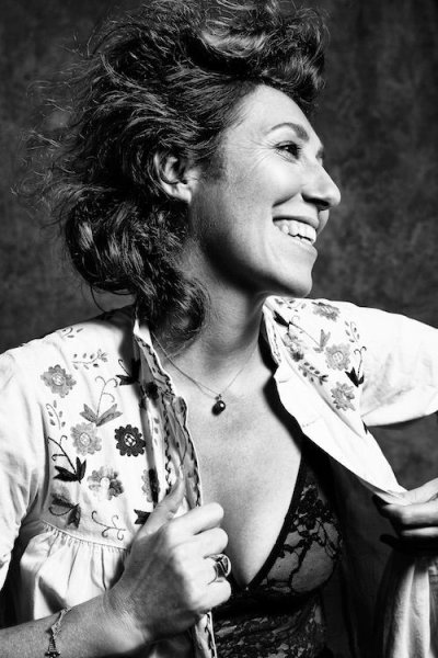 Martha smiling and looking away in black and white
