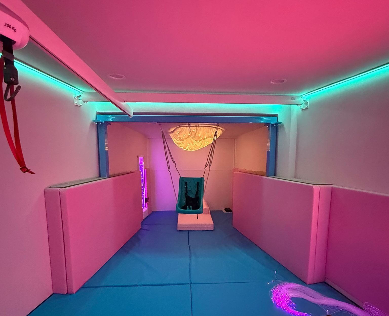 Sensory integration room with a suspended swing and padded floor