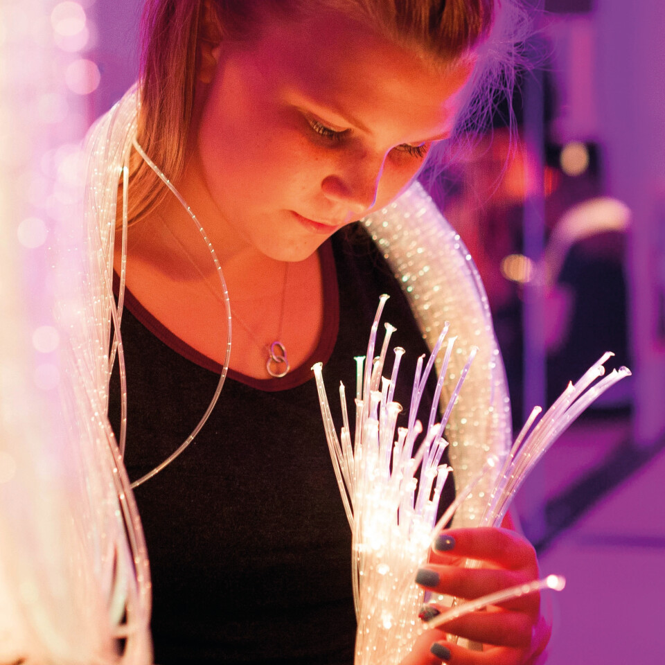 A child holding colour-changing fibre optic tails