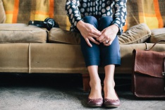 Photo of a woman sitting on a sofa 