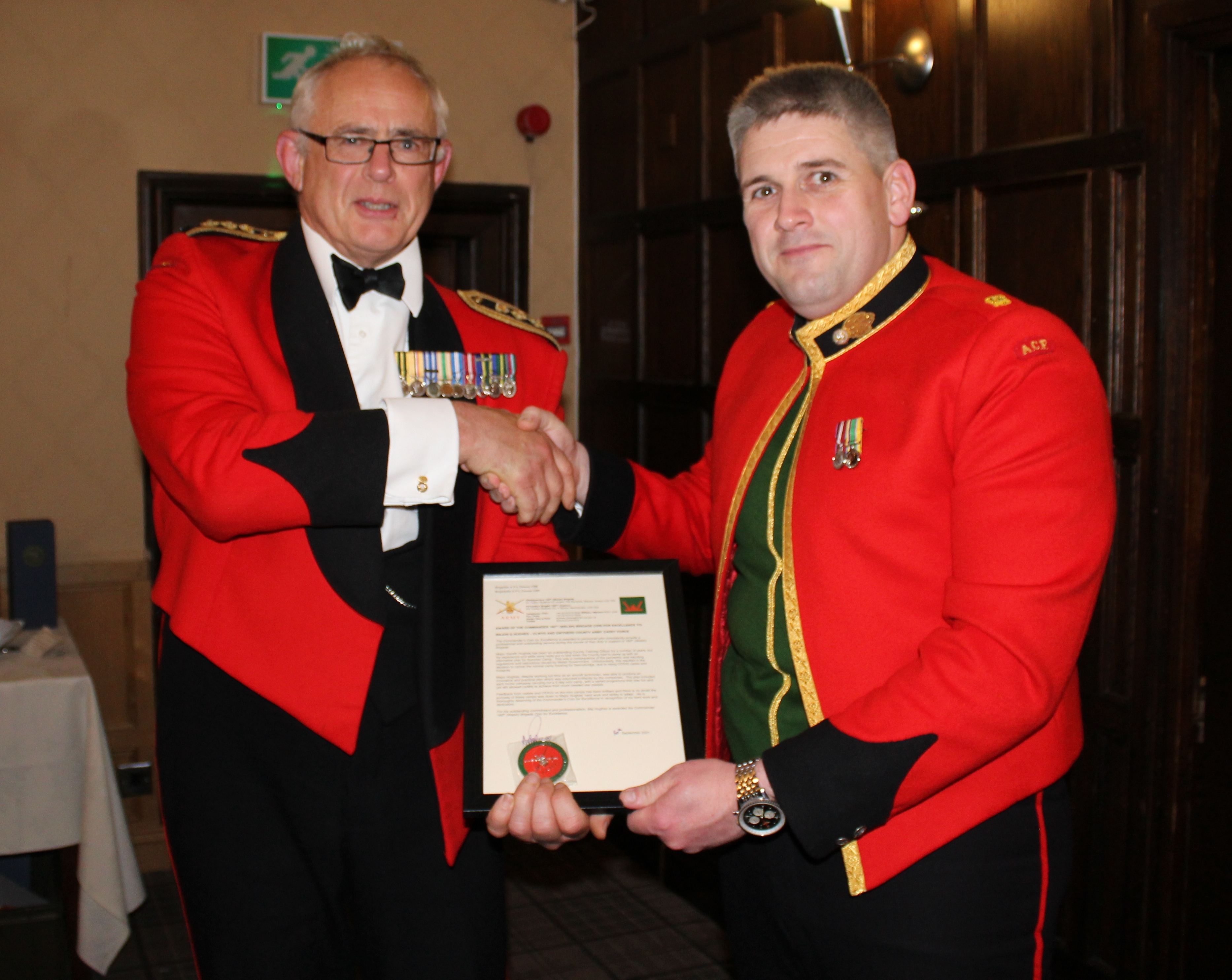 Gareth Hughes receives his Brigade Commanders Coin from Col LT Williams