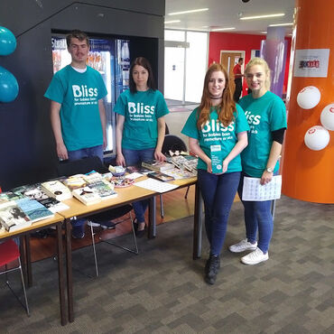 College students manning stall at th