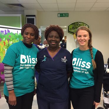 two women in Bliss t-shirts standing with a nurse at a world prematurity day fundraiser