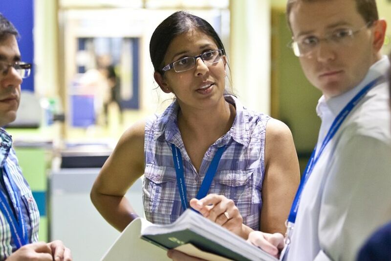 Doctors stood together speaking in a hospital setting