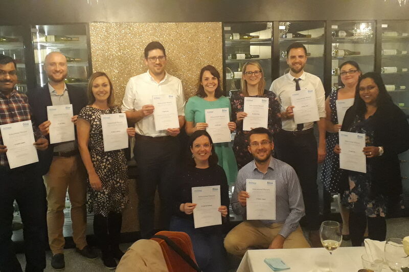 successful bursary applicants posing with their certificates