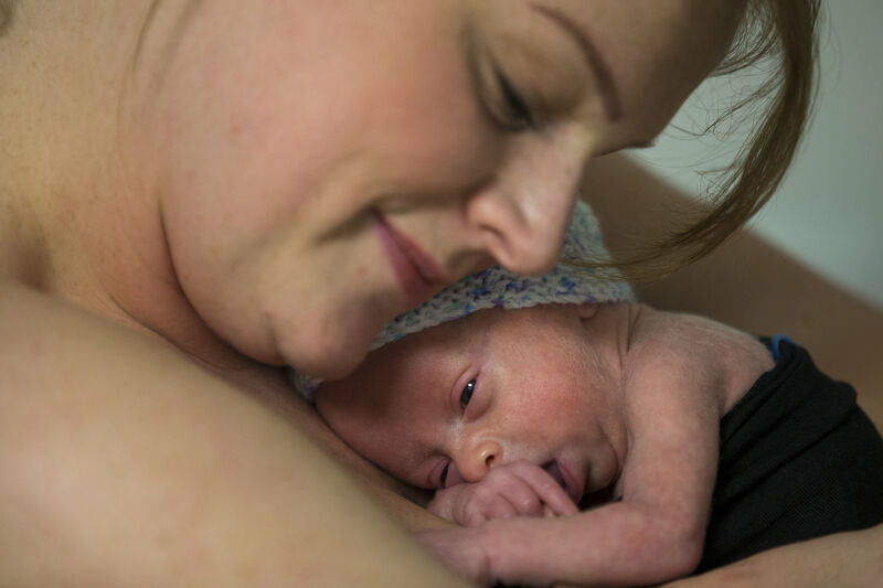 Mum cuddling baby on her chest skin to skin