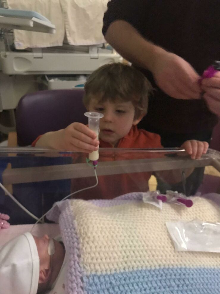 Big brother Louis like to help look after Anya on the unit