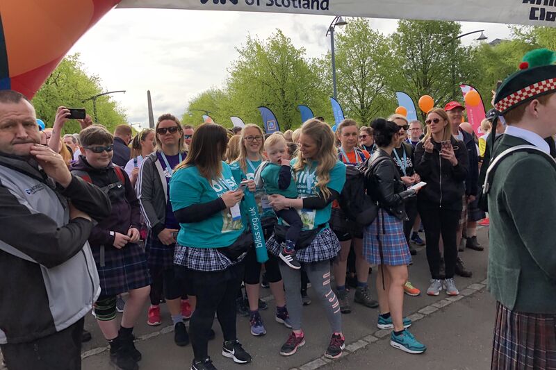 Bliss fundraisers wearing Bliss t-shirts standing at an event start line