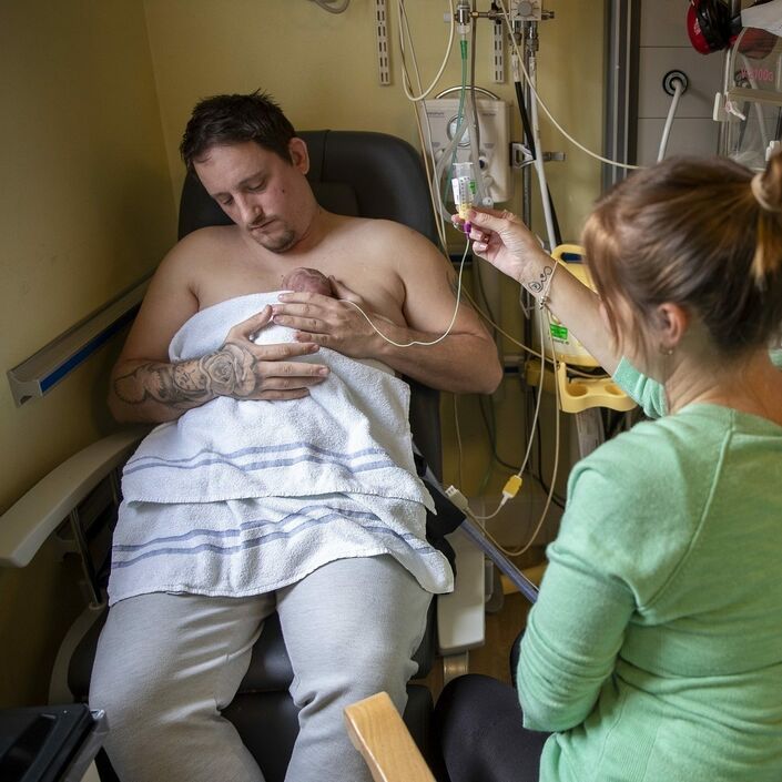 Parents doing skin-to-skin and tube feeding