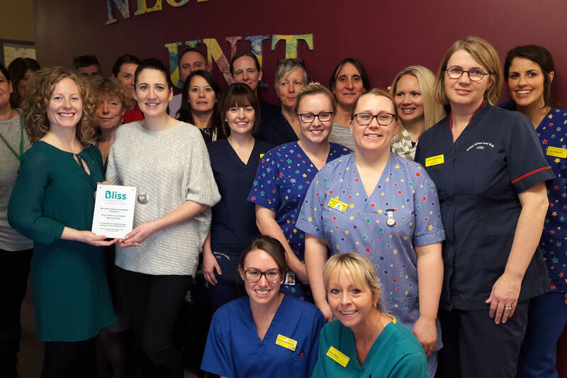 Staff at Royal Devon and Exeter hospital posing while holding a Bliss accreditation plaque