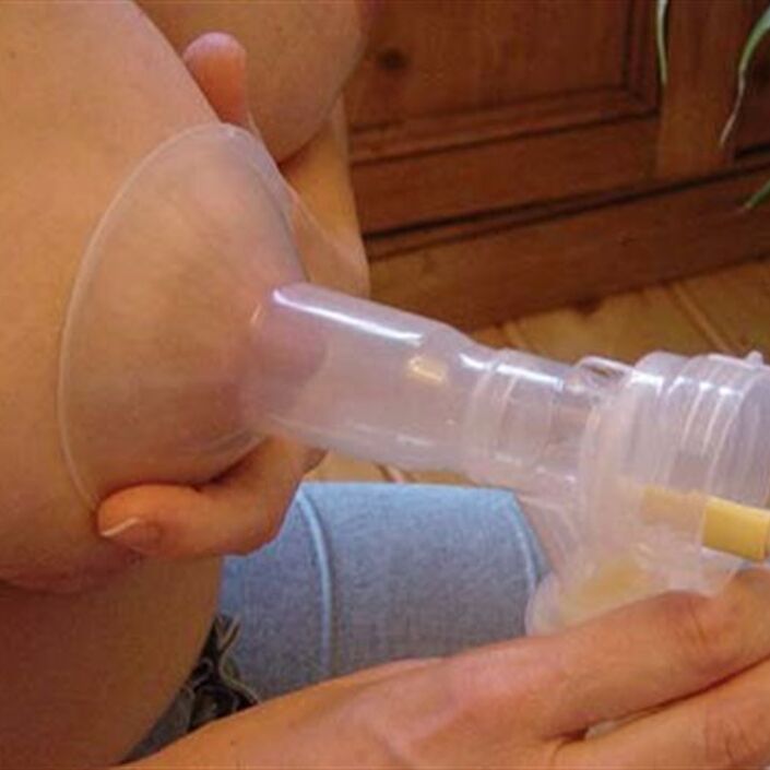 Breast expressing milk through a pump