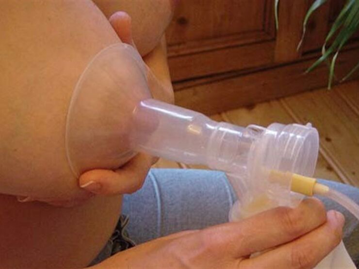 Breast expressing milk through a pump