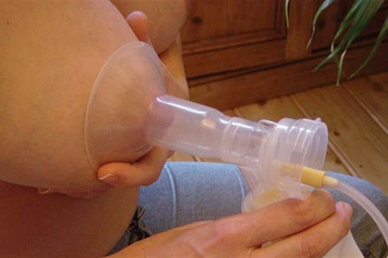 Breast expressing milk through a pump