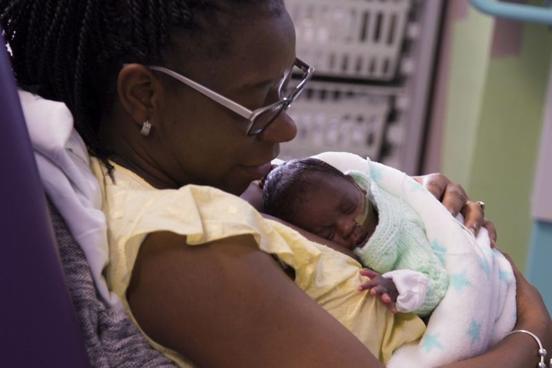 Woman holding her baby in a hospital
