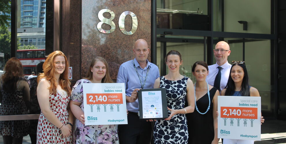 Bliss Chief Executive and Campaigns Manager posing with posters containing findings of 2015 Bliss baby report