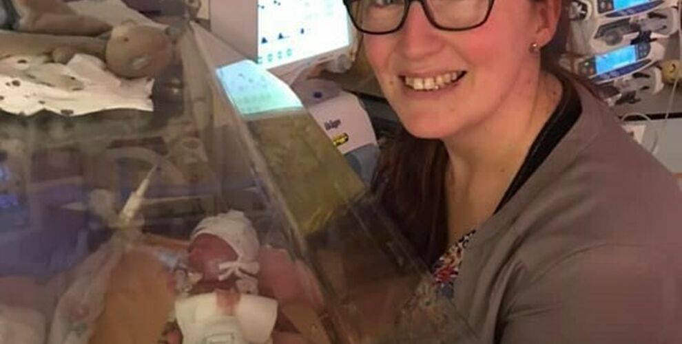 Jennie holding her son Rex, who is in an incubator in NICU