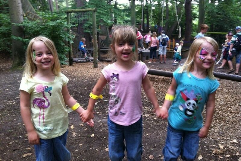 Kate, Holly and Jessica as small children, in a playground in a woodland