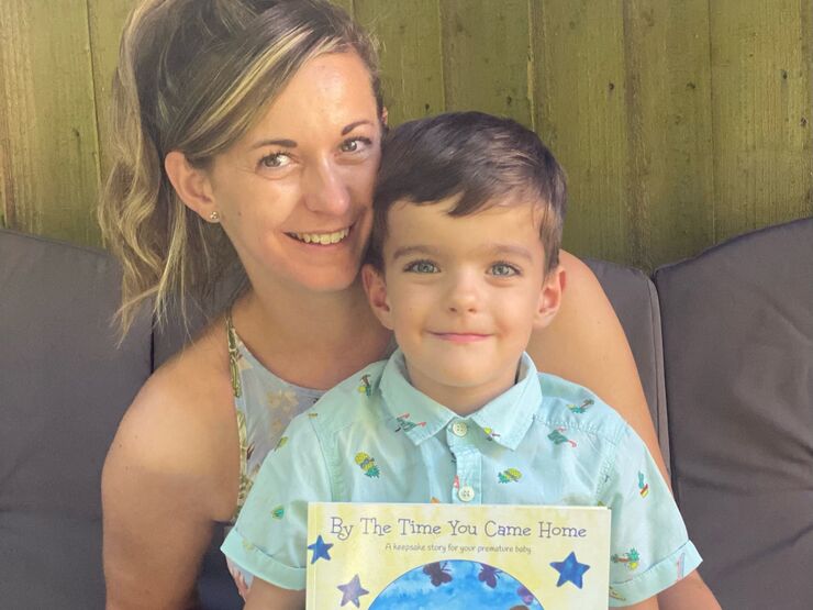 Sara and her son Ben, who is holding the children's book Sara wrote