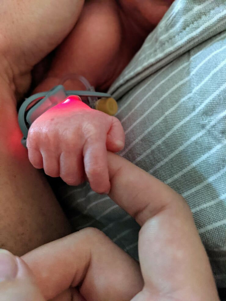 Dolly's baby holding her finger
