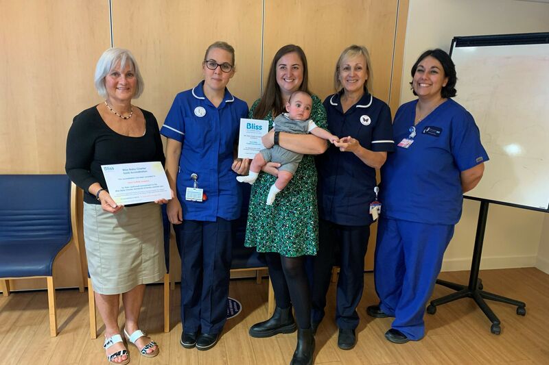 Some of the unit staff and a parent with her baby