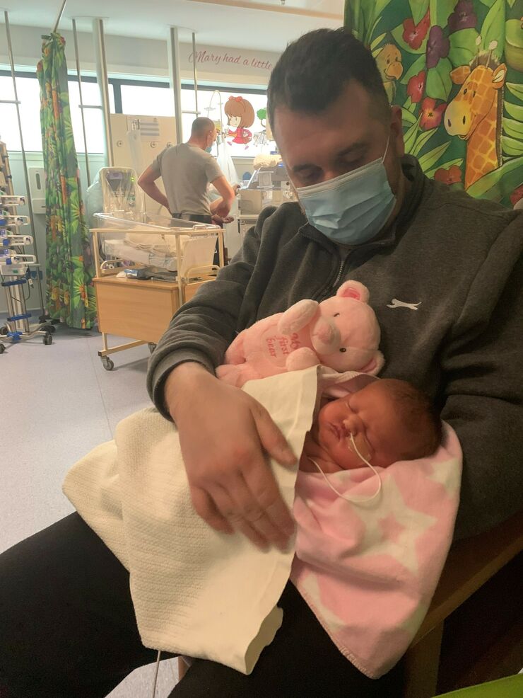 Kelly's husband with Lily on the unit