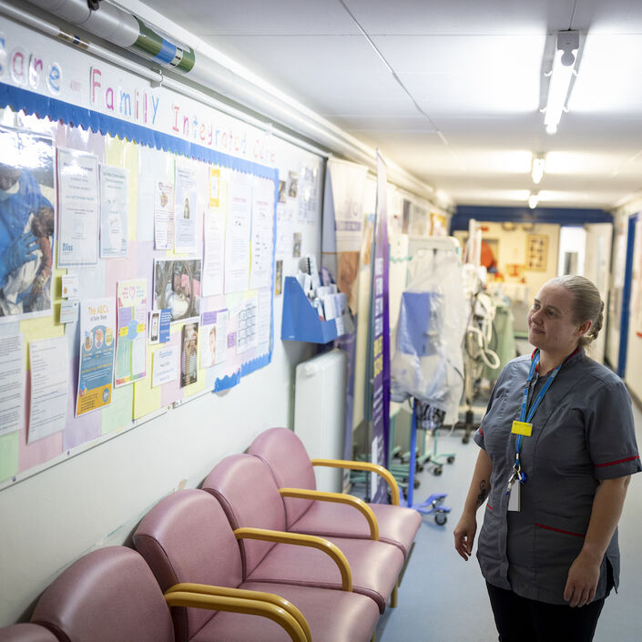 Nurse looking at a Family Integrated Care information board
