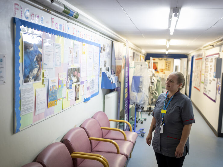 Nurse looking at a Family Integrated Care information board