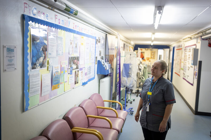 Nurse looking at a Family Integrated Care information board